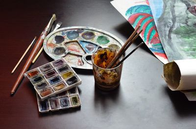 High angle view of multi colored drinking glass on table