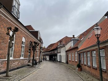 Empty alley amidst buildings in city