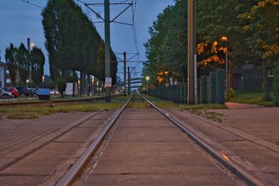 Railroad track in city against sky