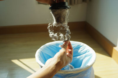 Close-up of hand holding dirty equipment at home