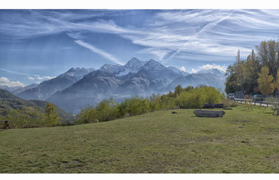 Grass field against mountain range