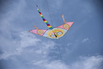 Low angle view of kite flying against sky