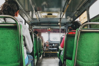 Rear view of passengers traveling in bus