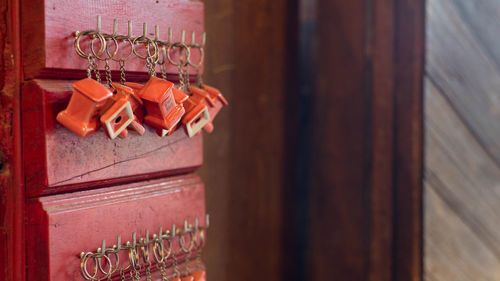 Close-up of key chains hanging for sale on hooks