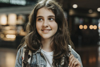 Smiling girl looking away at station