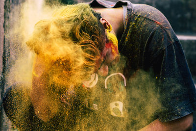 Young man covered with powder paint