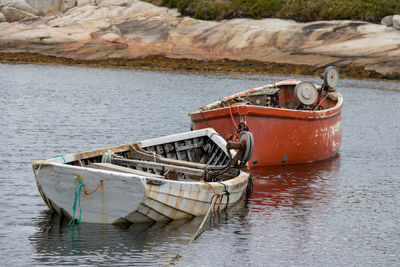 Abandoned boat moored on shore