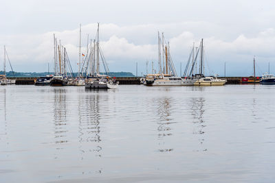View of the harbour of satralsund with sailboats moored. view with reflections on water