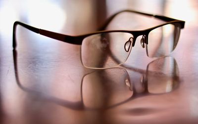 Close-up of sunglasses on glass table