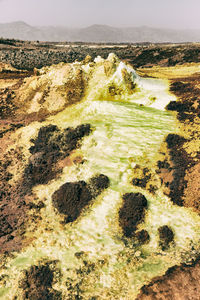 Aerial view of land and sea against sky