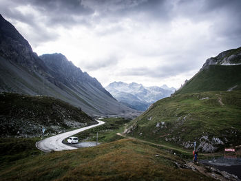 Road amidst snowcapped mountains against sky