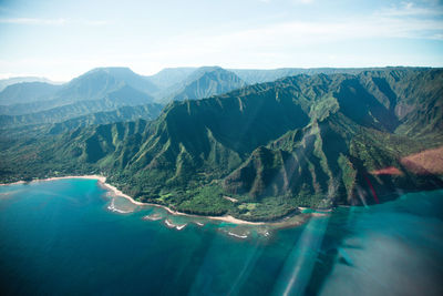 Scenic view of rock mountains by sea