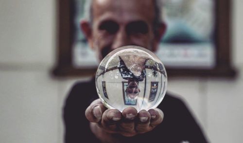 Close-up portrait of a man holding glass