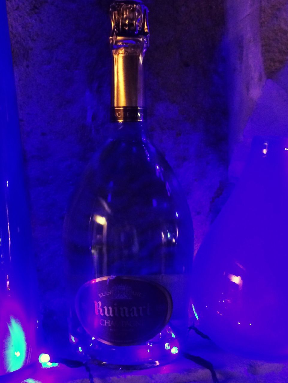 bottle, indoors, blue, illuminated, alcohol, no people, close-up, drink, drinking glass, night