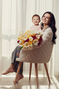 Portrait of smiling woman holding gift box