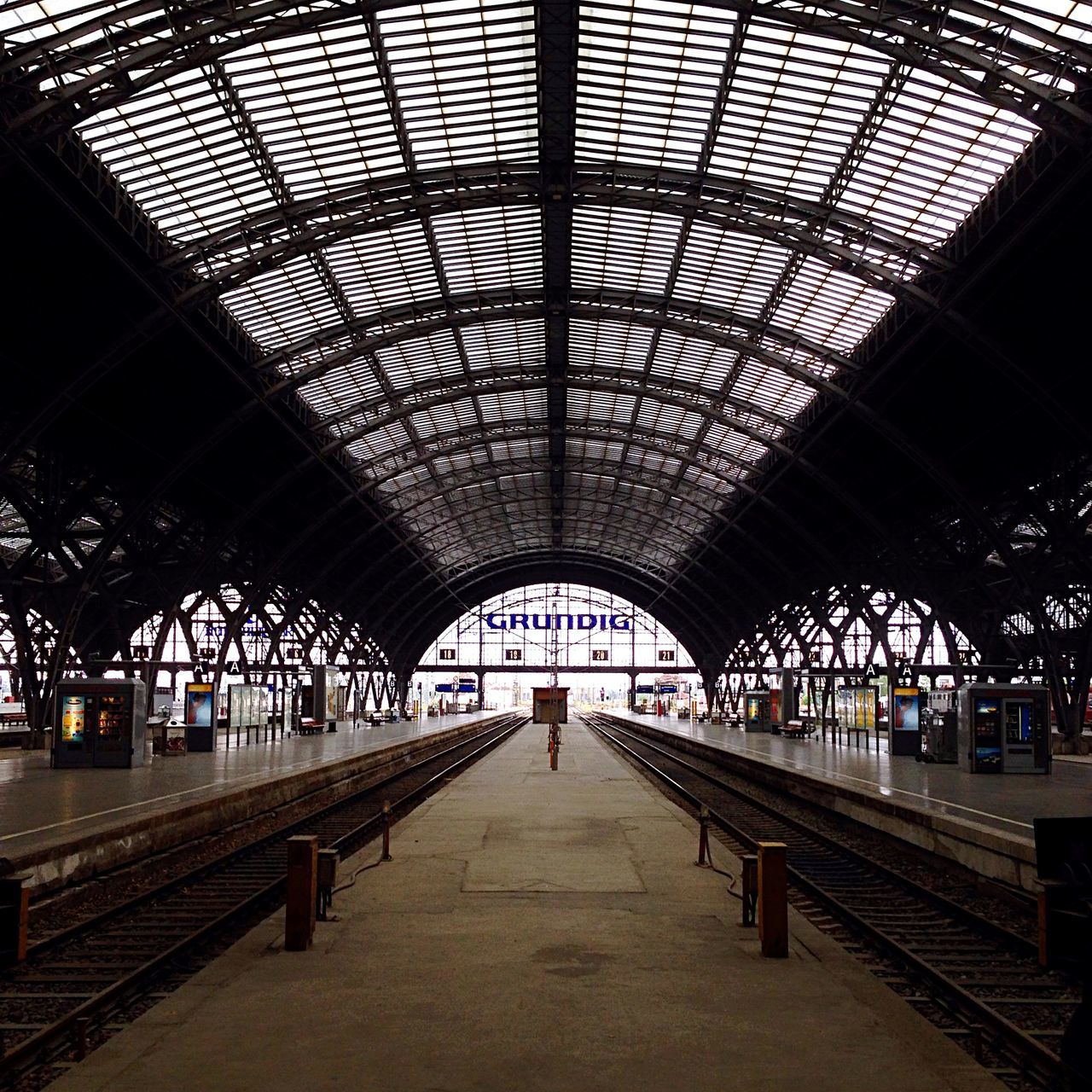 indoors, ceiling, architecture, built structure, the way forward, rail transportation, diminishing perspective, railroad station, railroad track, transportation, railroad station platform, public transportation, vanishing point, incidental people, interior, empty, arch, tunnel, transportation building - type of building, long