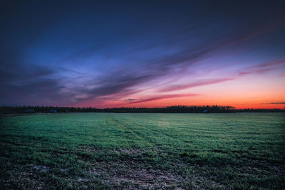 Scenic view of field against sky during sunset