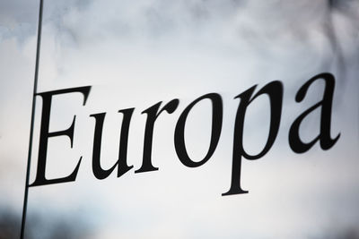 Low angle view of sign against sky