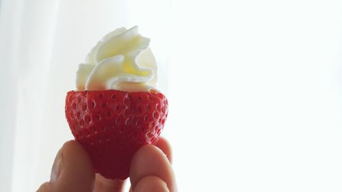 Close-up of hand holding ice cream