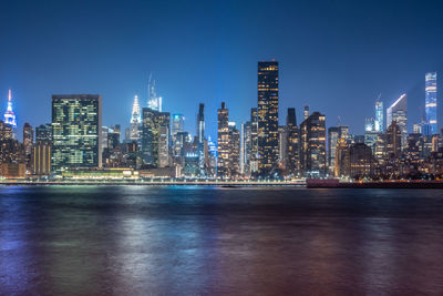 Illuminated buildings against sky at night