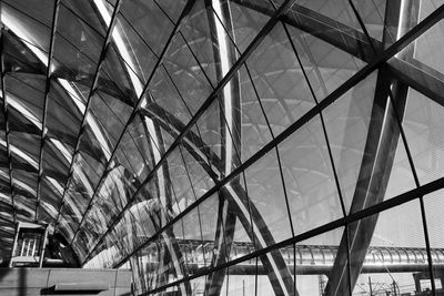 Low angle view of modern building seen through glass ceiling