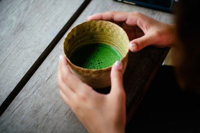 Close-up of hand holding tea cup