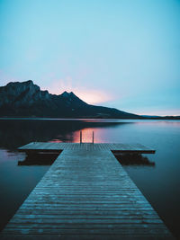 Pier over lake against sky