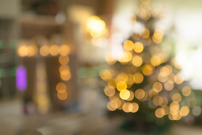 Defocused image of illuminated christmas lights at night