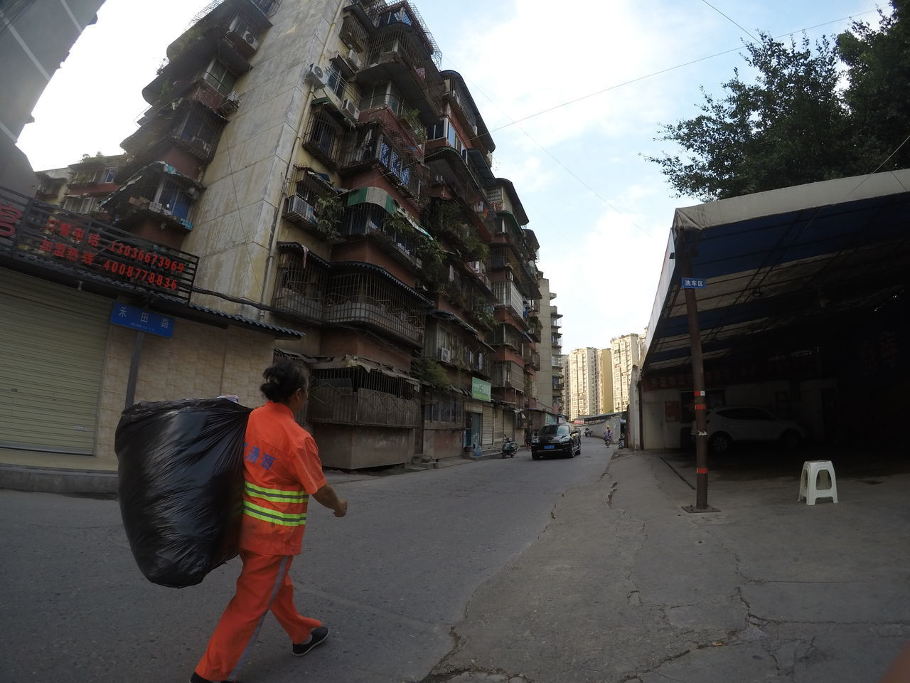 REAR VIEW OF PEOPLE WALKING ON STREET