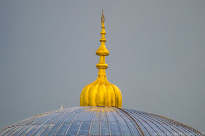 High section of bell tower against sky