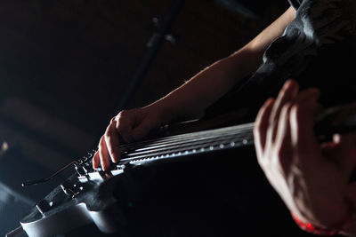 Close-up of hand playing guitar