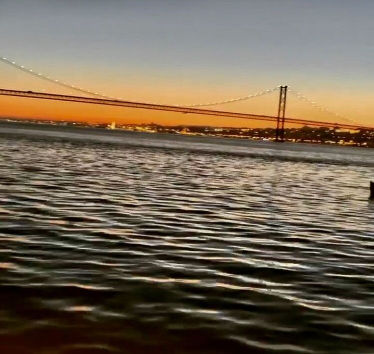 SCENIC VIEW OF BRIDGE OVER SEA AGAINST SKY DURING SUNSET