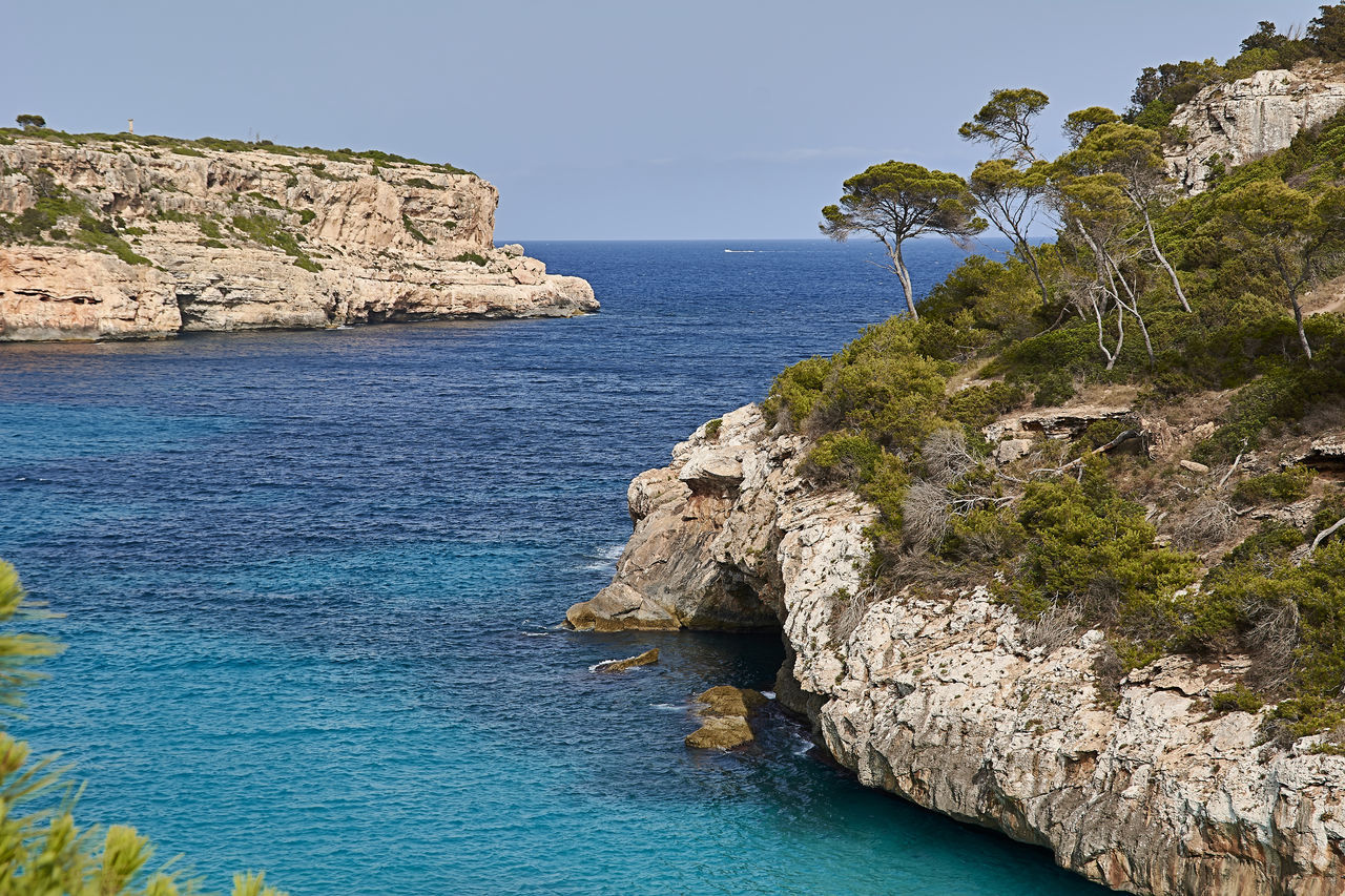 SCENIC VIEW OF SEA AGAINST ROCK FORMATION