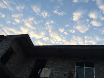 Low angle view of building against cloudy sky