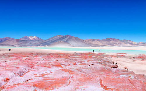 Scenic view of desert against blue sky