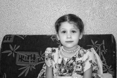 Portrait of boy sitting on sofa at home