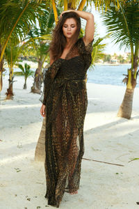 Portrait of young woman standing at beach