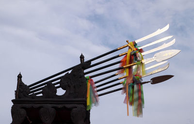 Low angle view of traditional windmill against sky