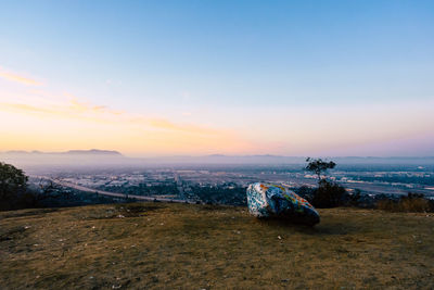 Scenic view of cityscape at sunset from hilltop 