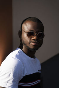 Man with glasses posing at camera.