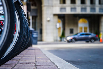 Cropped image of motorcycles on sidewalk