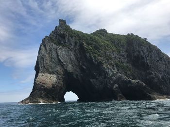 Low angle view of rock formation against sky