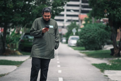 Full length of man standing on footpath