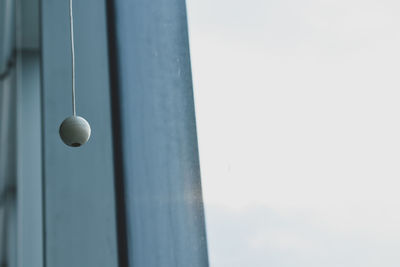 Low angle view of electric lamp against sky