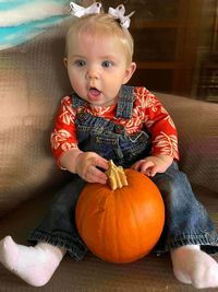 Portrait of cute girl with pumpkin