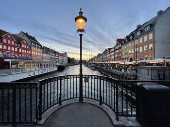 Street by buildings against sky in city