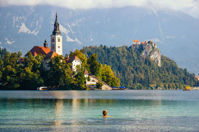 View of woman swimming in lake bled