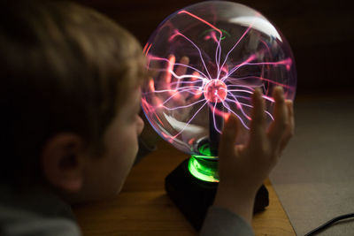 Midsection of girl holding illuminated light