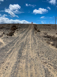 View of tire tracks on dirt road