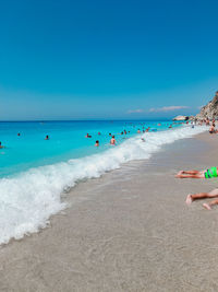 Scenic view of beach against clear blue sky